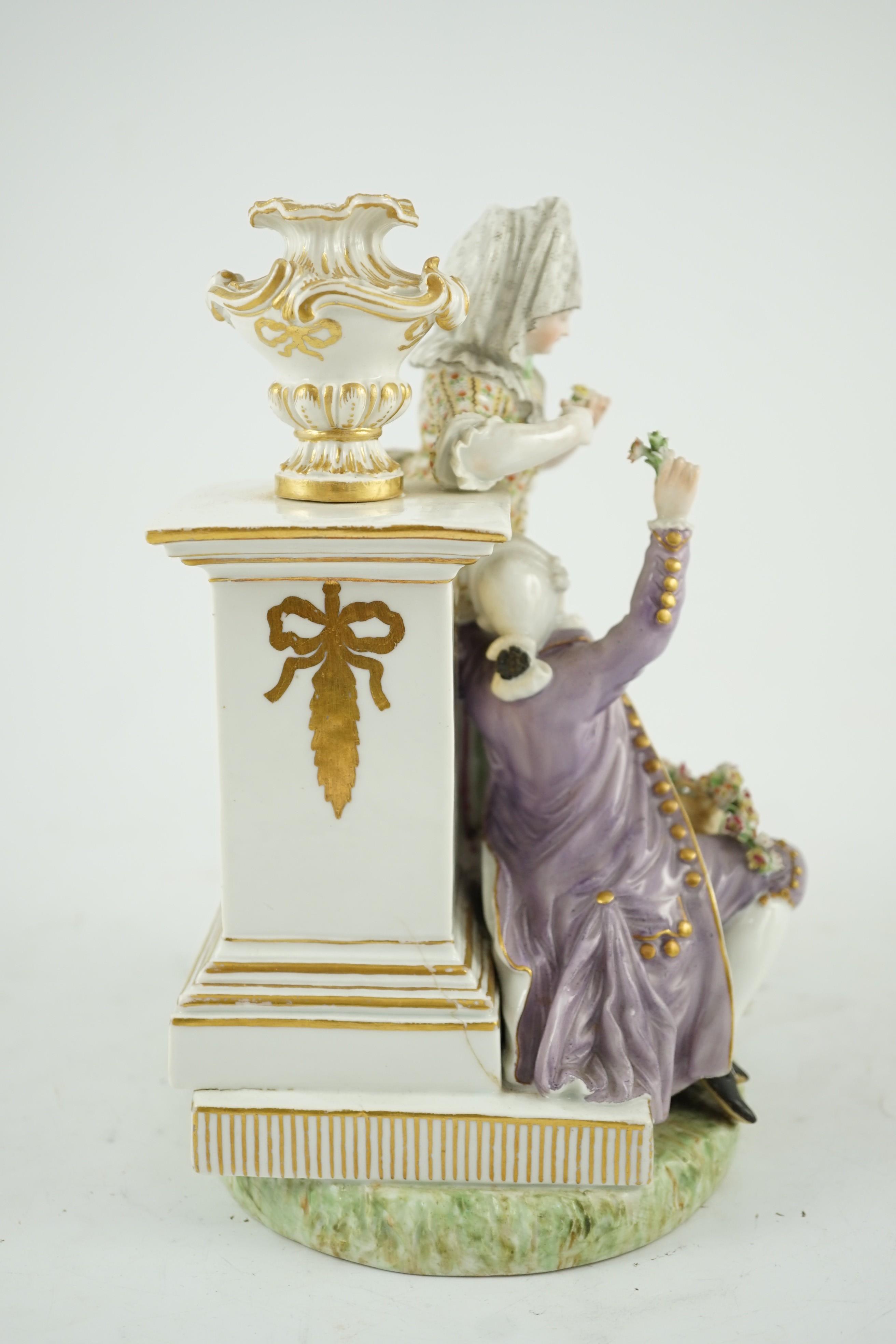 A Meissen porcelain group of a maid and a gallant by a pedestal, 19th century, 22cm high, crack to base